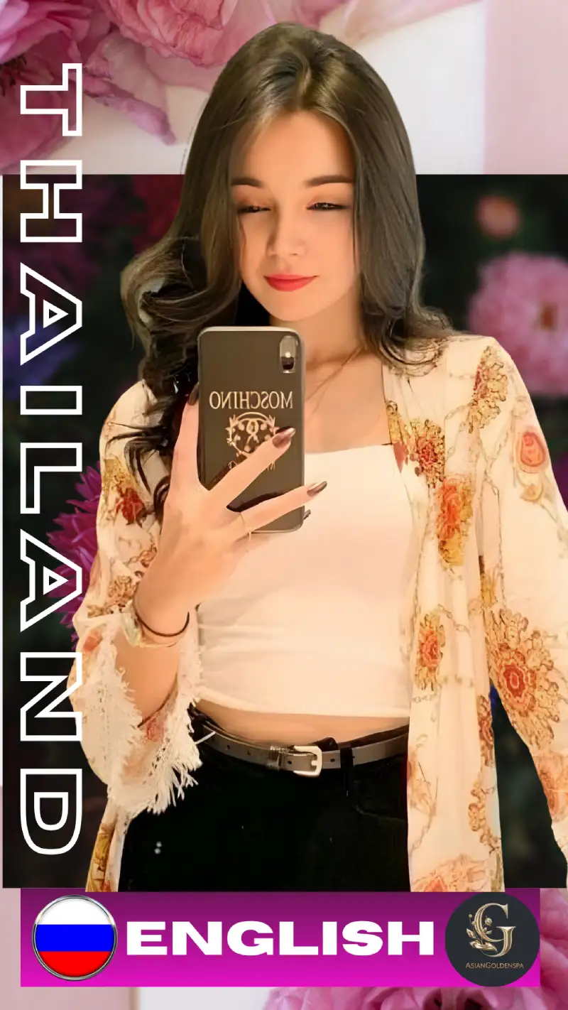 Thai woman taking a mirror selfie with a smartphone, wearing a white crop top, floral shawl, and black pants. She has long brown hair and red lips. Background includes pink and purple flowers. Text on the image reads "THAILAND" and "ENGLISH" with a Russian flag and Asian Golden Spa logo. Promotional content for Asian Golden Spa in Ras Al Khaimah.