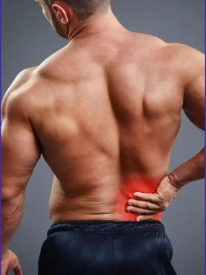 Man holding lower back in pain indicating muscle strain or injury – physiotherapy or massage therapy needed in Ras Al Khaimah, Nakheel, Prime Hotel – Asian Golden Spa – Contact: 056 978 9770