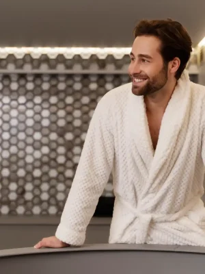 Man in white robe enjoying spa sauna experience at Asian Golden Spa, RAK Nakheel Prime Hotel