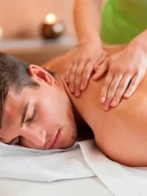 Man getting a relaxing back massage at Asian Golden Spa, Nakheel Prime Hotel, Ras Al Khaimah – soft hands pressing shoulder muscles in a calm spa room